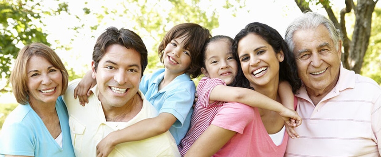multigenerational smiling family of moms, dads, children
