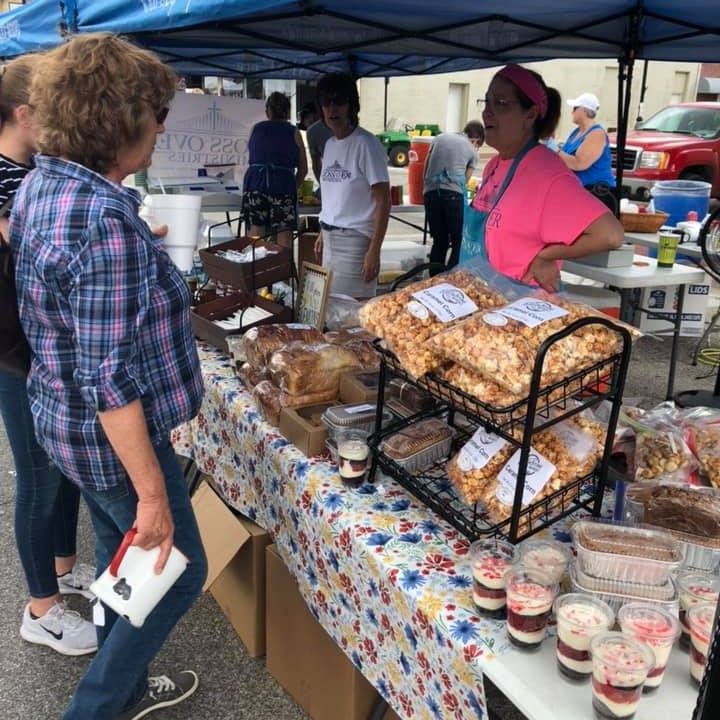 volunteers serve desserts at pickers event