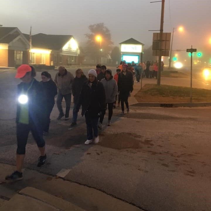 group walk at dawn in fog