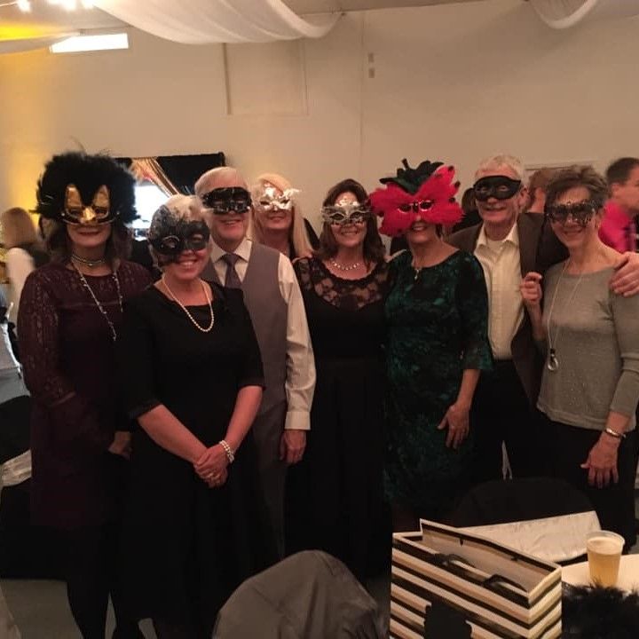 Cross Over Ministries board in masquerade group photo at hospital fundraiser